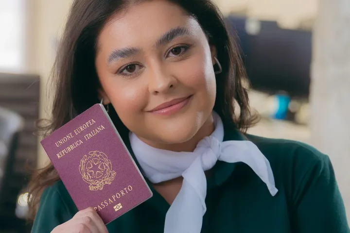 Cuanto sale el pasaporte italiano: Mujer mostrando su pasaporte italiano