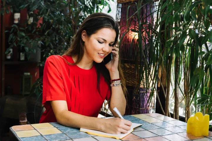 Mujer utilizando las guías telefónicas de Italia para rastrear sus raíces familiares.